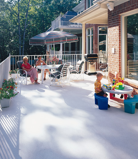 Covered porch with seating on DeckRite vinyl overlooking a lawn