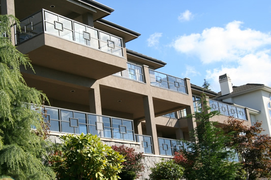Multi-level condominium balconies with glass and metal rails