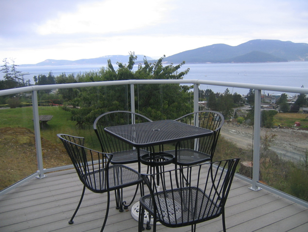 Round waterfront balcony with a table and chairs on a vinyl surface