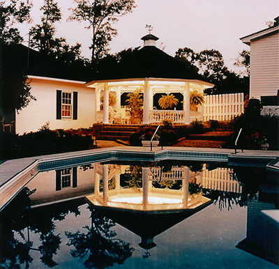 Gazebo and pool house with DeckRite vinyl surrounding a swimming pool