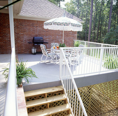 Raised residential sundeck finished in DeckRite vinyl with white railing