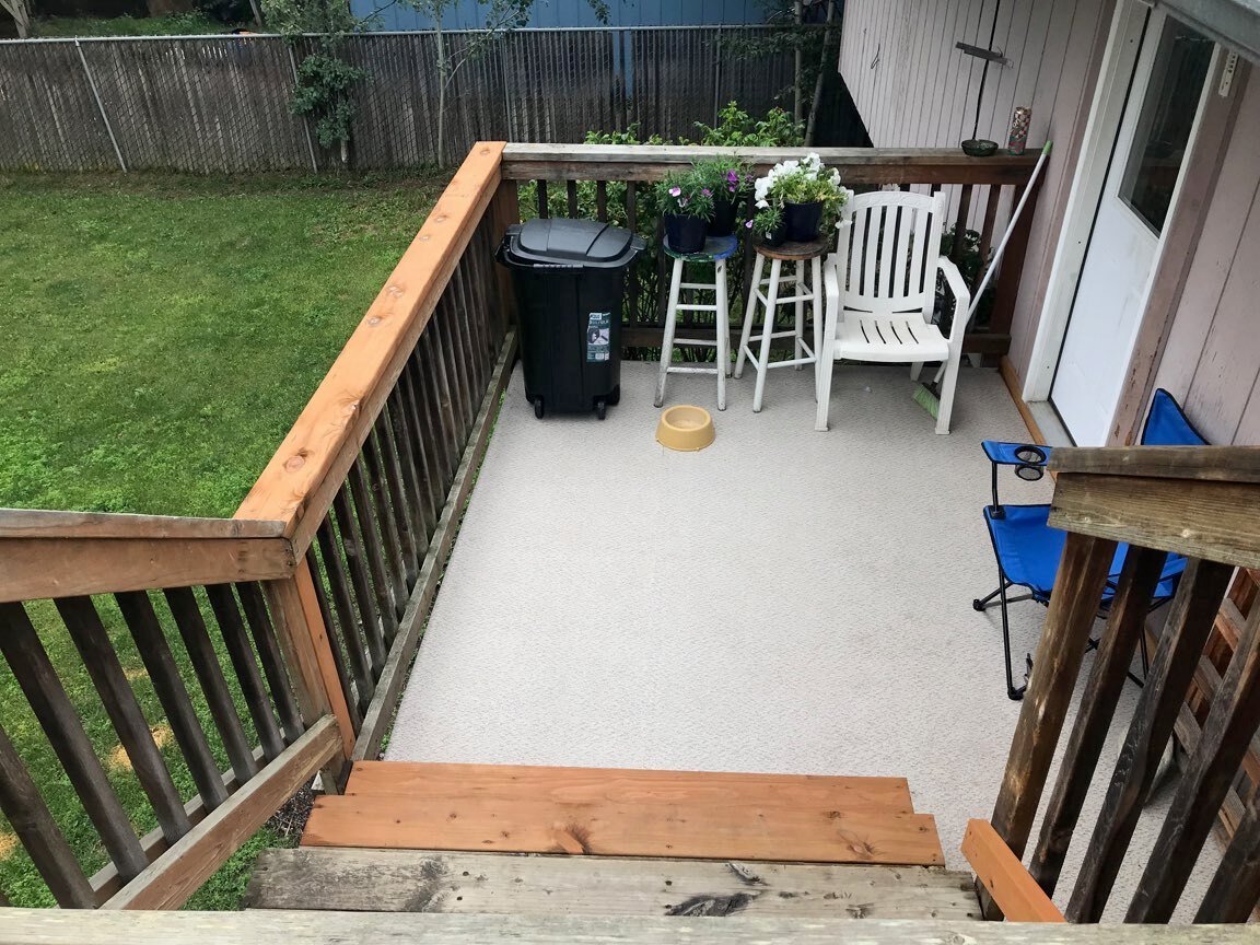 Vinyl-covered porch with wood railing in Anchorage
