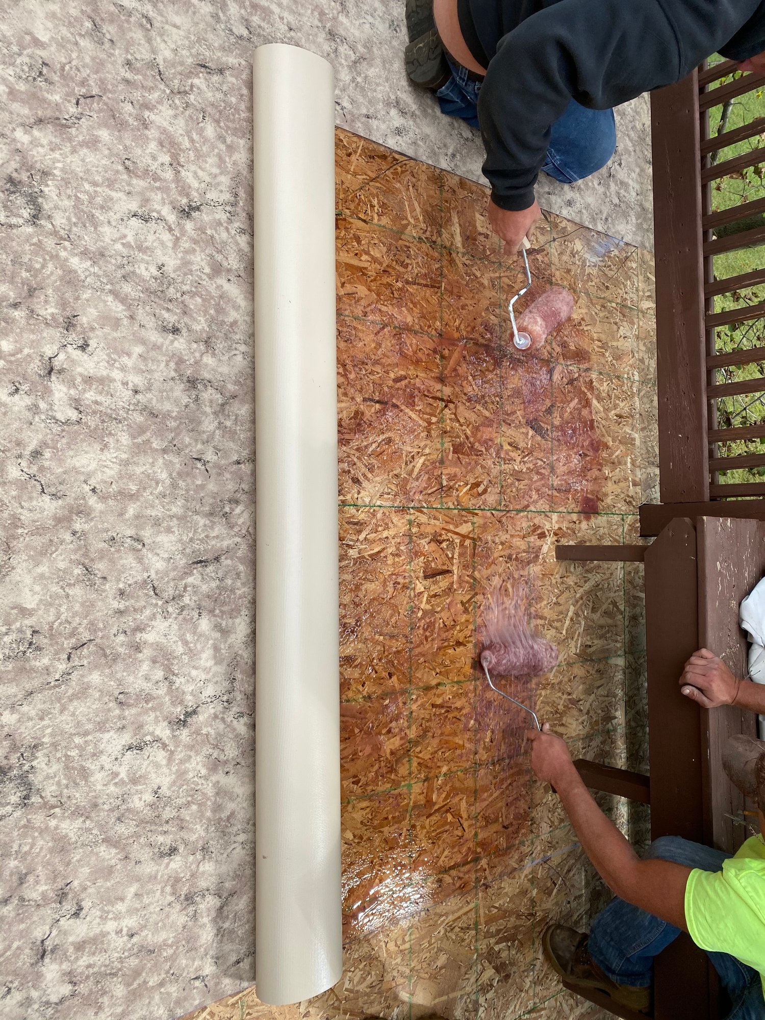 Tuscany Sand vinyl being rolled onto a prepared deck in Michigan