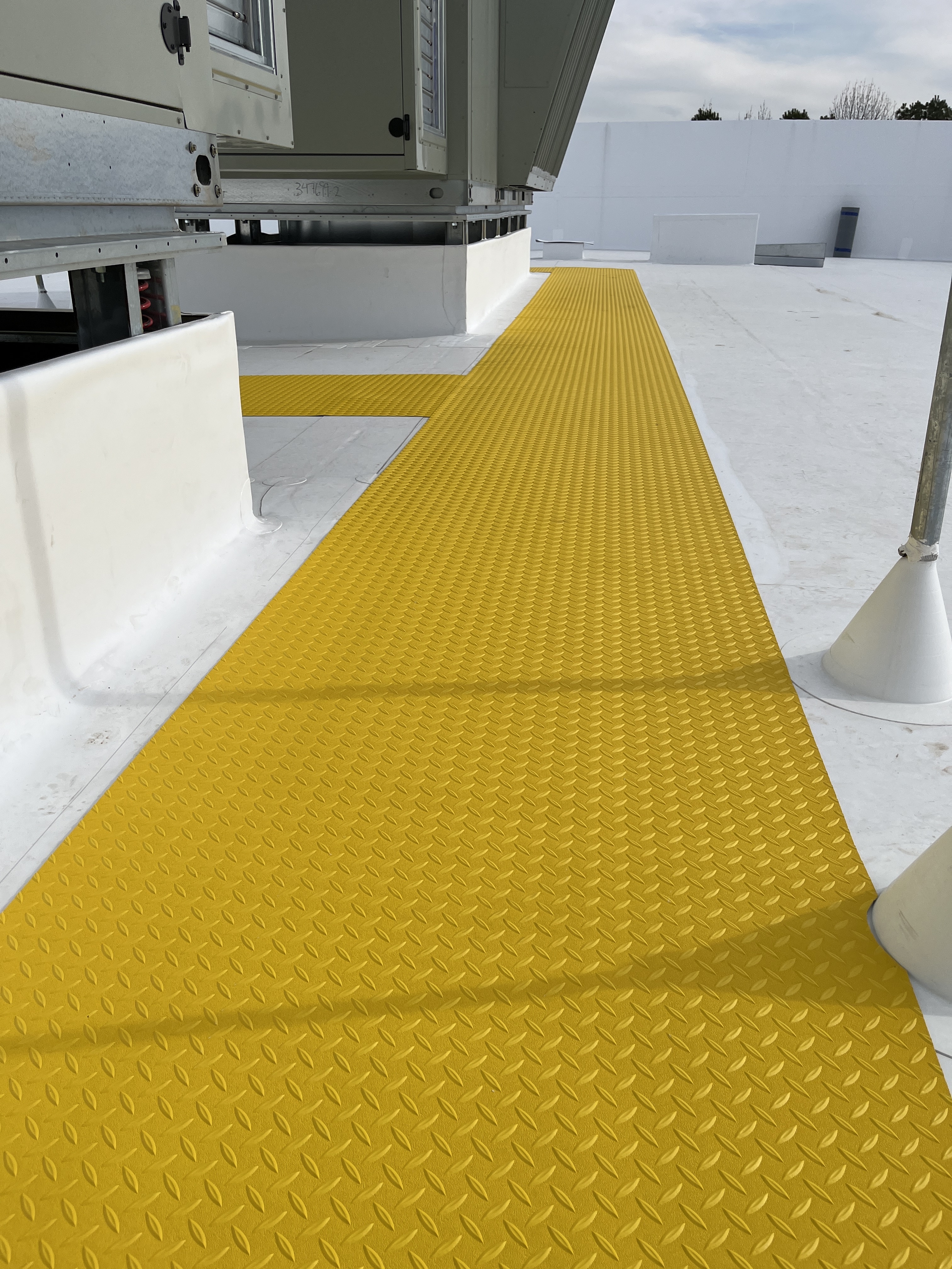 ProGuard yellow walk tread path on a commercial roof